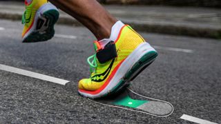 Person running in Saucony running shoes with the NURVV Run attached to the shoes