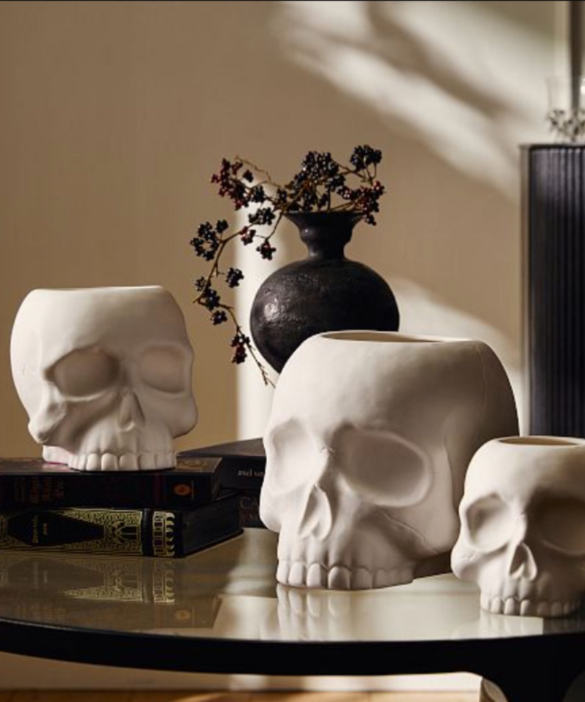 White skull candles on on glass table