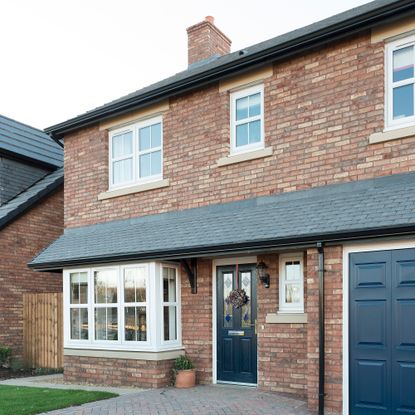 Exterior of brick house with bay window