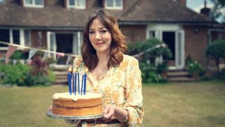 Donna (Diane Morgan) holding a birthday cake