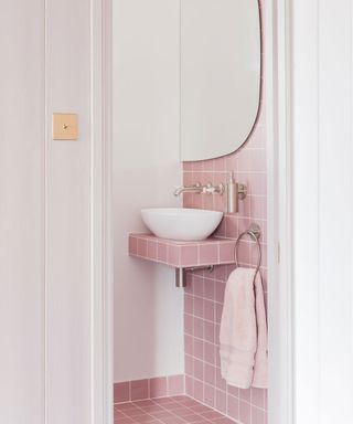 bathroom with pink wall and white basin
