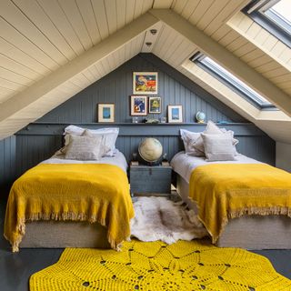 Loft bedroom with twin beds and yellow crochet rug