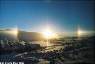 This beautiful picture was captured at sunrise on a cold and still Park City morning. Called sundogs, this phenomenon is caused by sunlight being refracted through ice crystals. Taken by Don Brown with an Olympus OM1 and a 28mm lens, this image shows two parhelia on each side of the sun and one just visible at the top of the image. The ice crystals must be preferentially oriented horizontally and the sun-observer line of sight must be close to horizontal in order to see such a site.