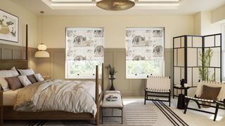 bedroom with large bed, patterned roller blinds and sitting chairs with clean, neutral decor