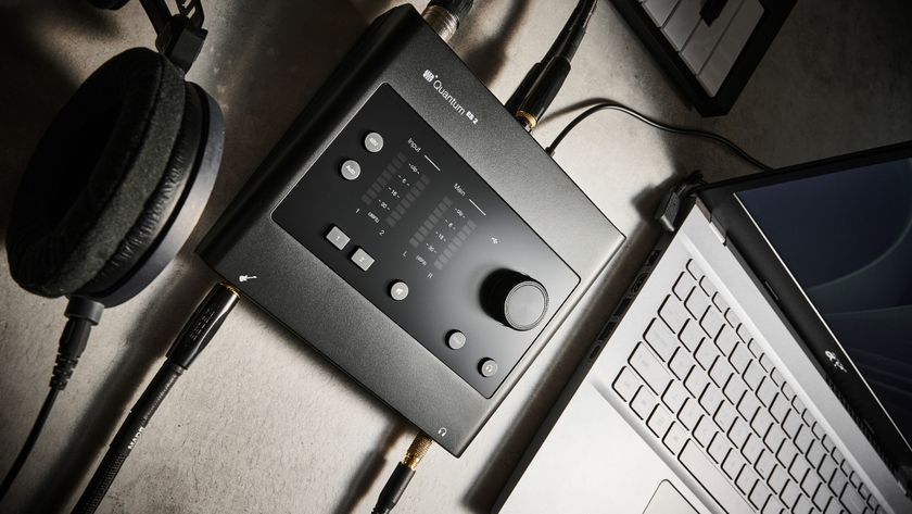 A PreSonus audio interface connected to a laptop and a pair of studio headphones