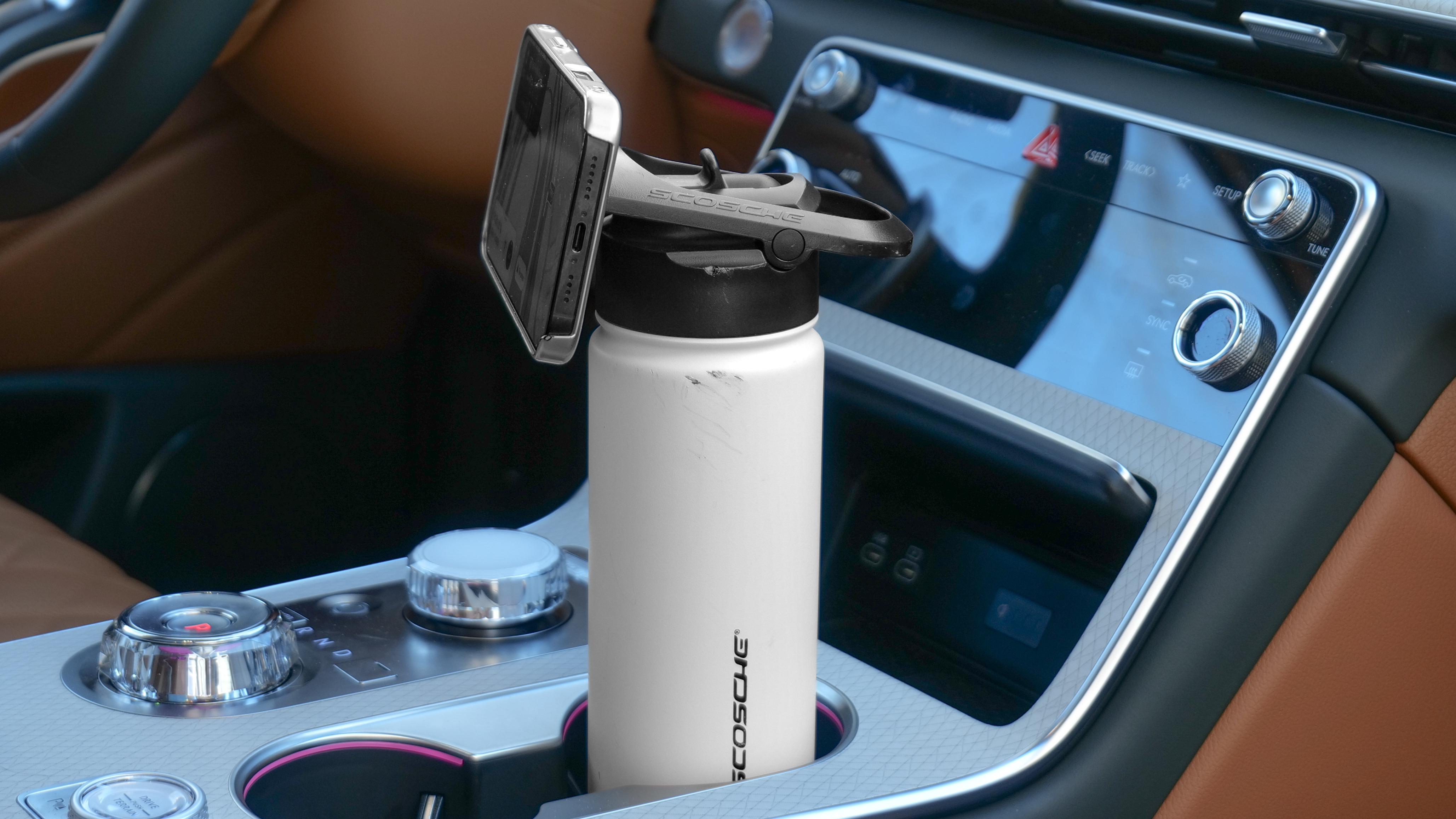 Scosche MagicMount Flask used in car cup holder with iPhone connected to it via MagSafe.