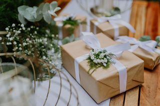 Wedding presents in eco-friendly wrapper paper on a table next to plants