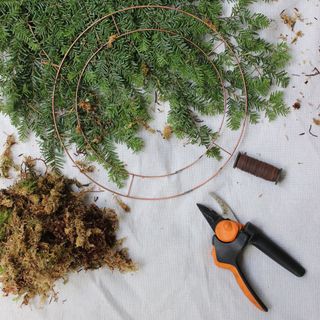 A spool of florists' wire with hardy scissors and natural moss