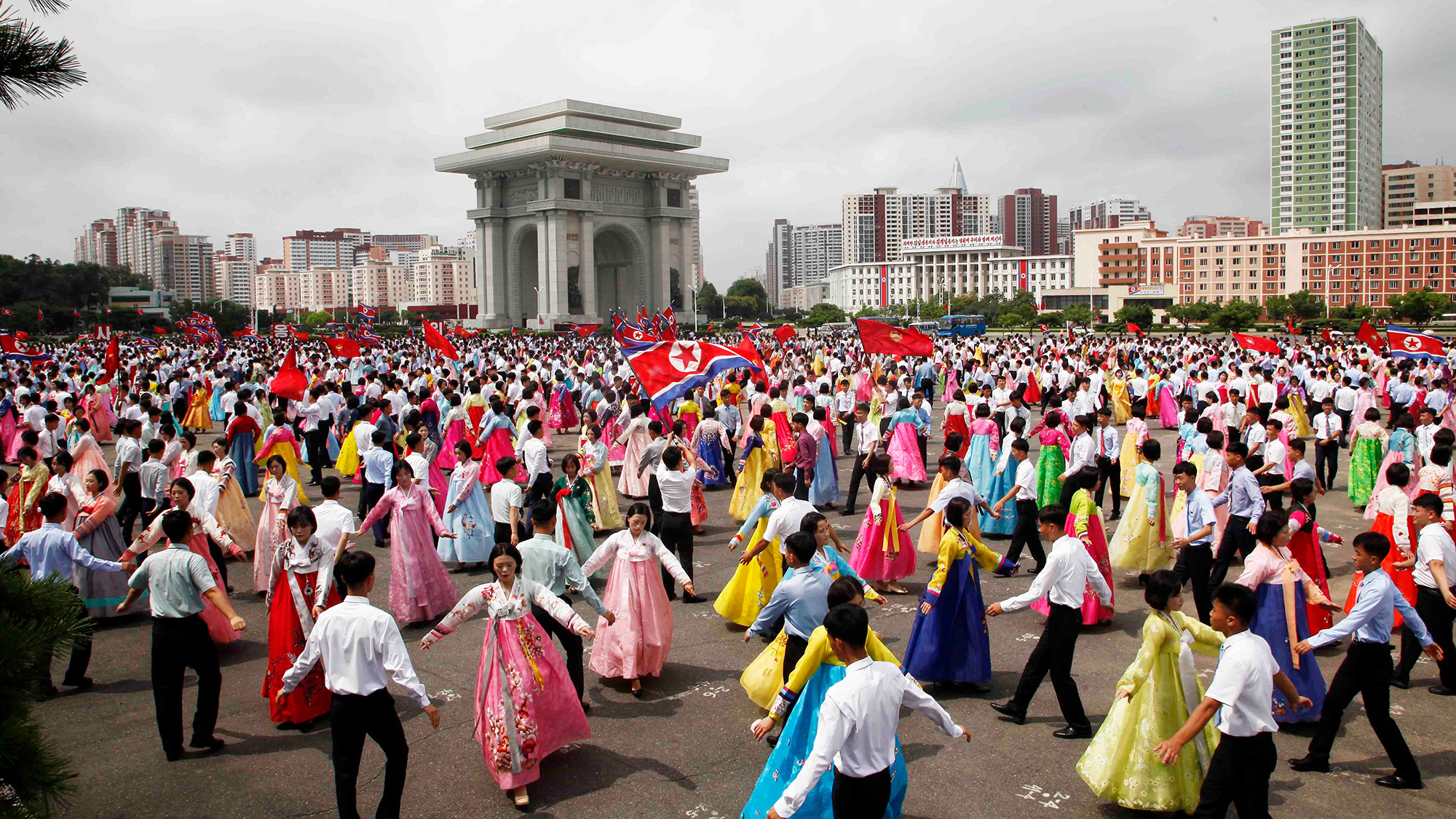People dance during an event to mark the anniversary of the Korean War, at the plaza of the Arch of Triumph in Pyongyang, North Korea