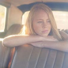 woman in a car looking contemplative