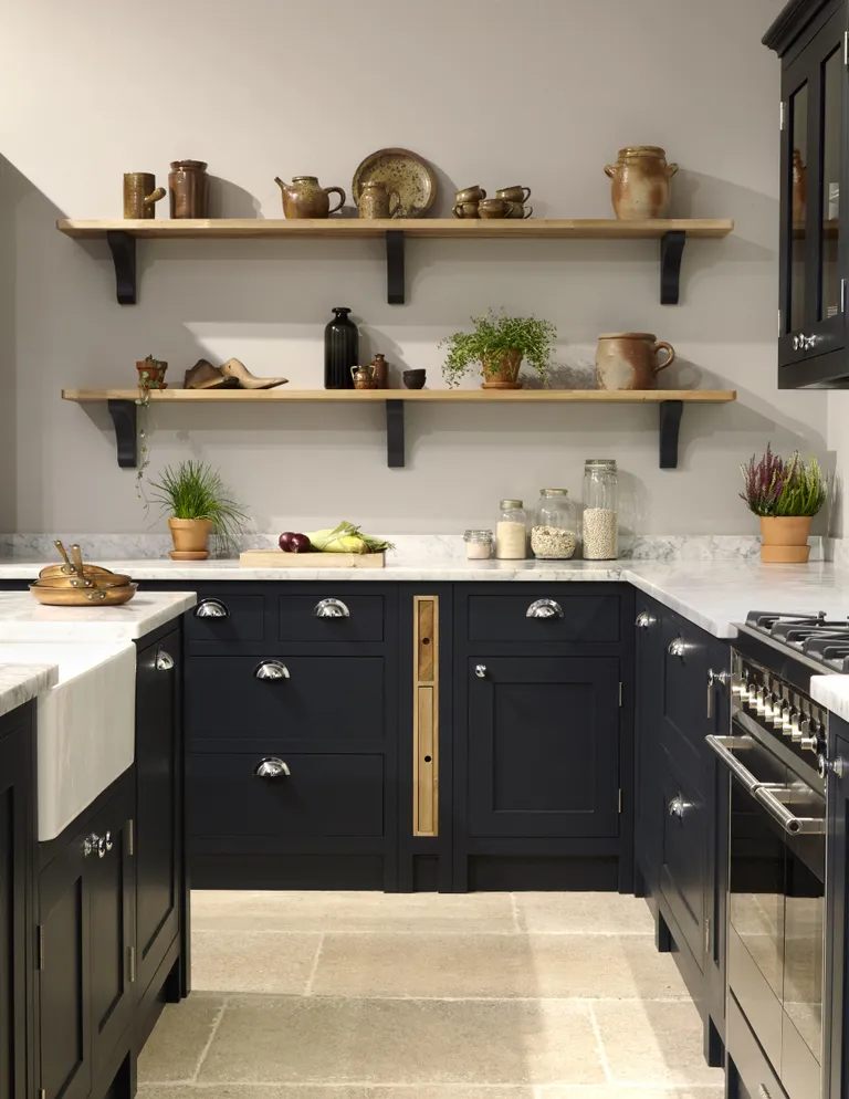 Dark Shaker kitchen with marble worktop and wall shelves
