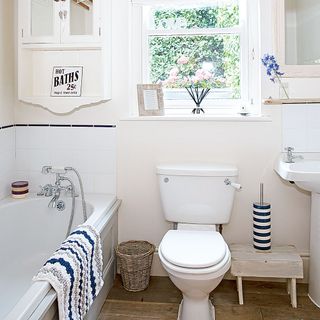 bathroom with white tub and wooden flooring
