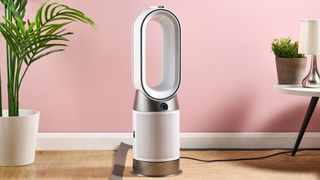 The Dyson HP10 purifying fan heater is pictured in a pink living room.