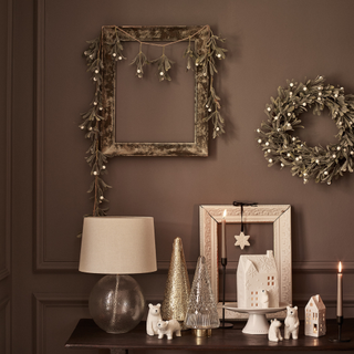 ceramic tree, house and polar bear ornaments on cabinet