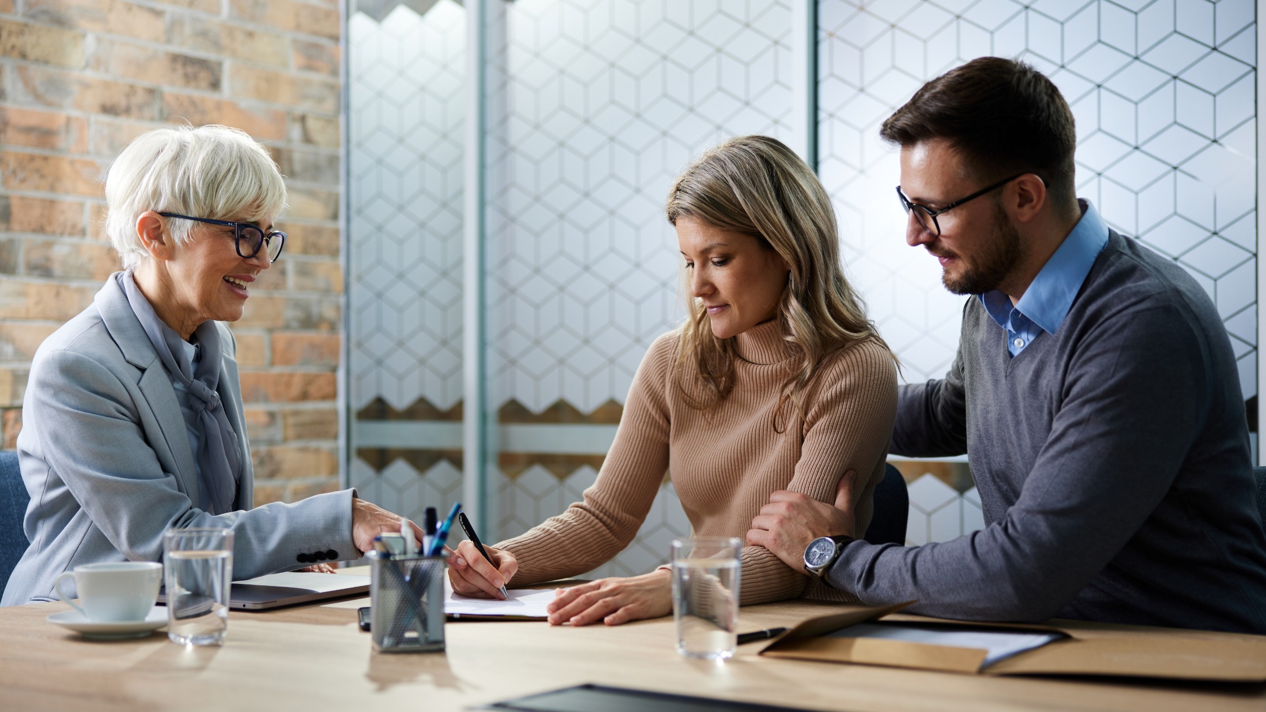 A financial adviser helps a couple manage their finances.