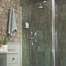 A green-tiled bathroom with a shower