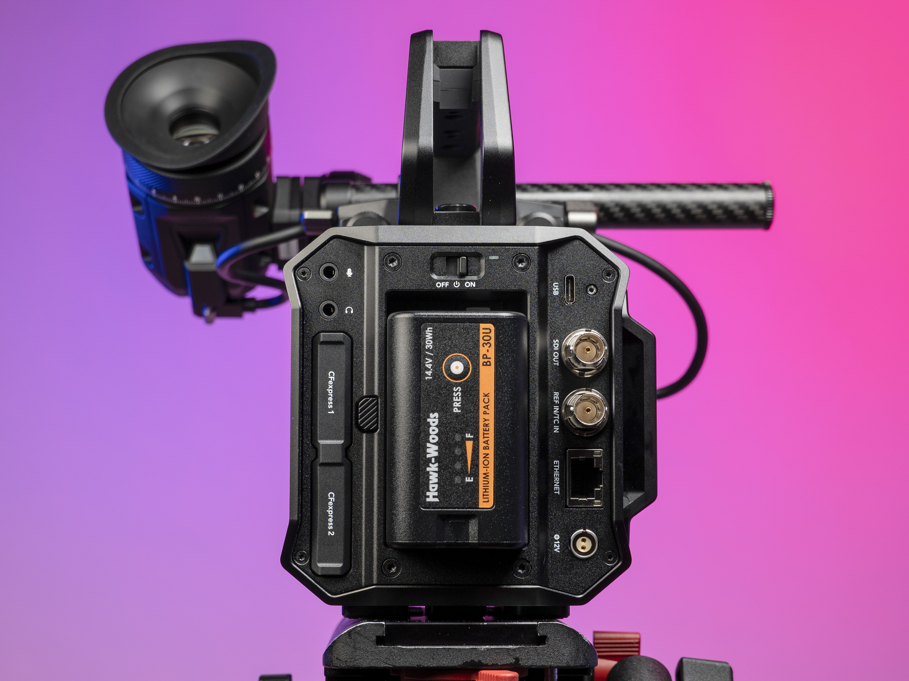 Rear of the Blackmagic Pyxis 6K camera, in the studio with a vibrant magenta background