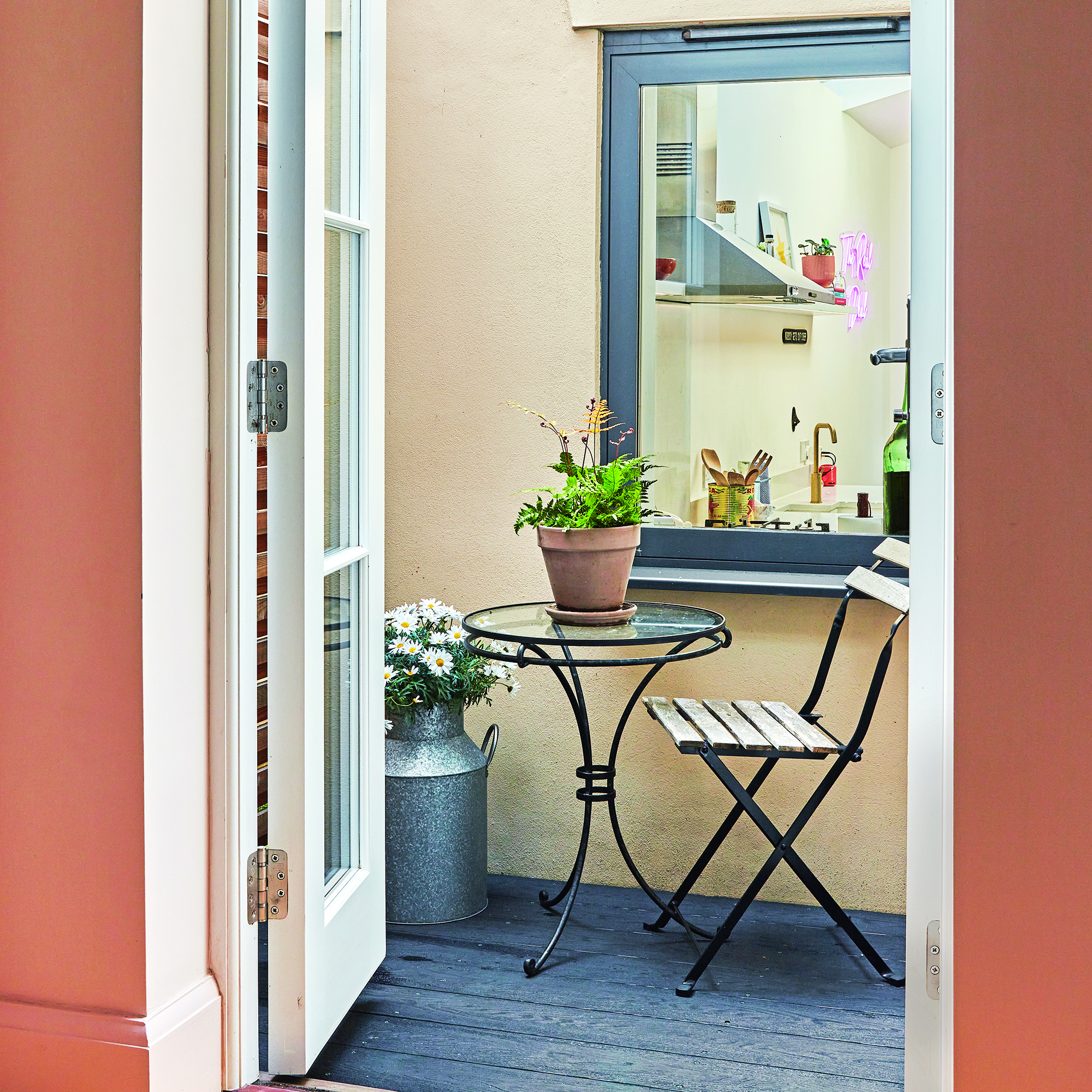 Bistro table in greenhouse area near kitchen