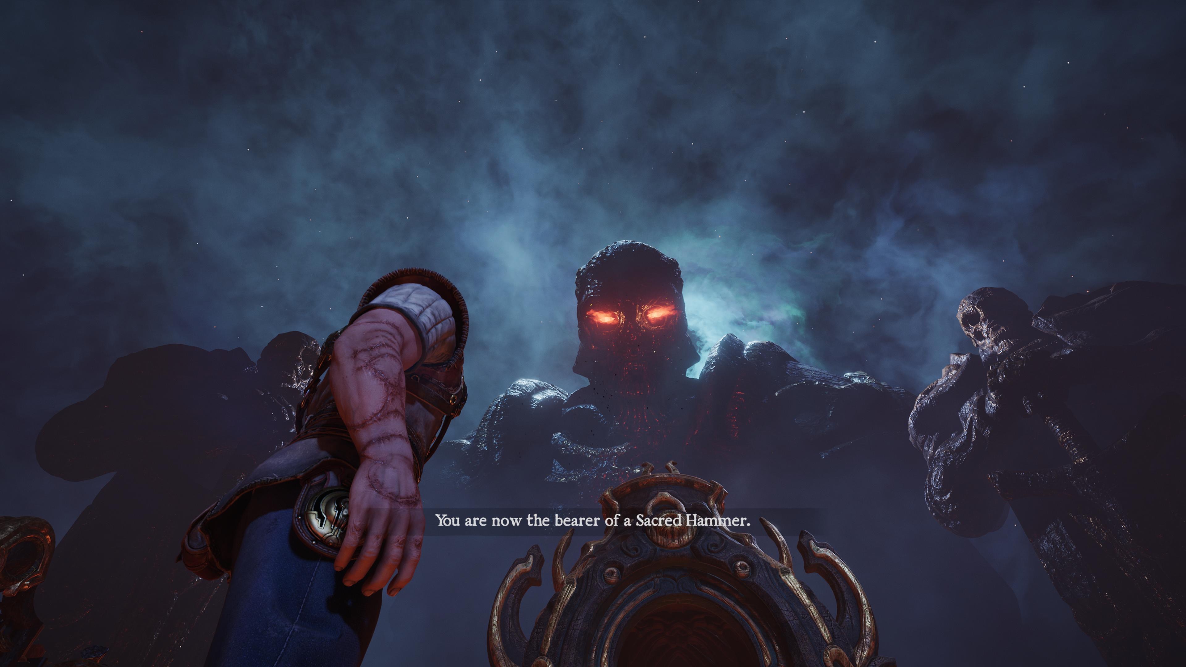 A giant being gazes down at Aran with blazing eyes in Blades of Fire saying "You are now the bearer of the Sacred Hammer"