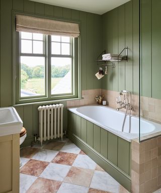 small bathroom with marble checkerboard tiles and green paneled walls