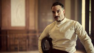 Joshua Sasse in a white fencing jacket as Oswald Mosley in Outrageous.