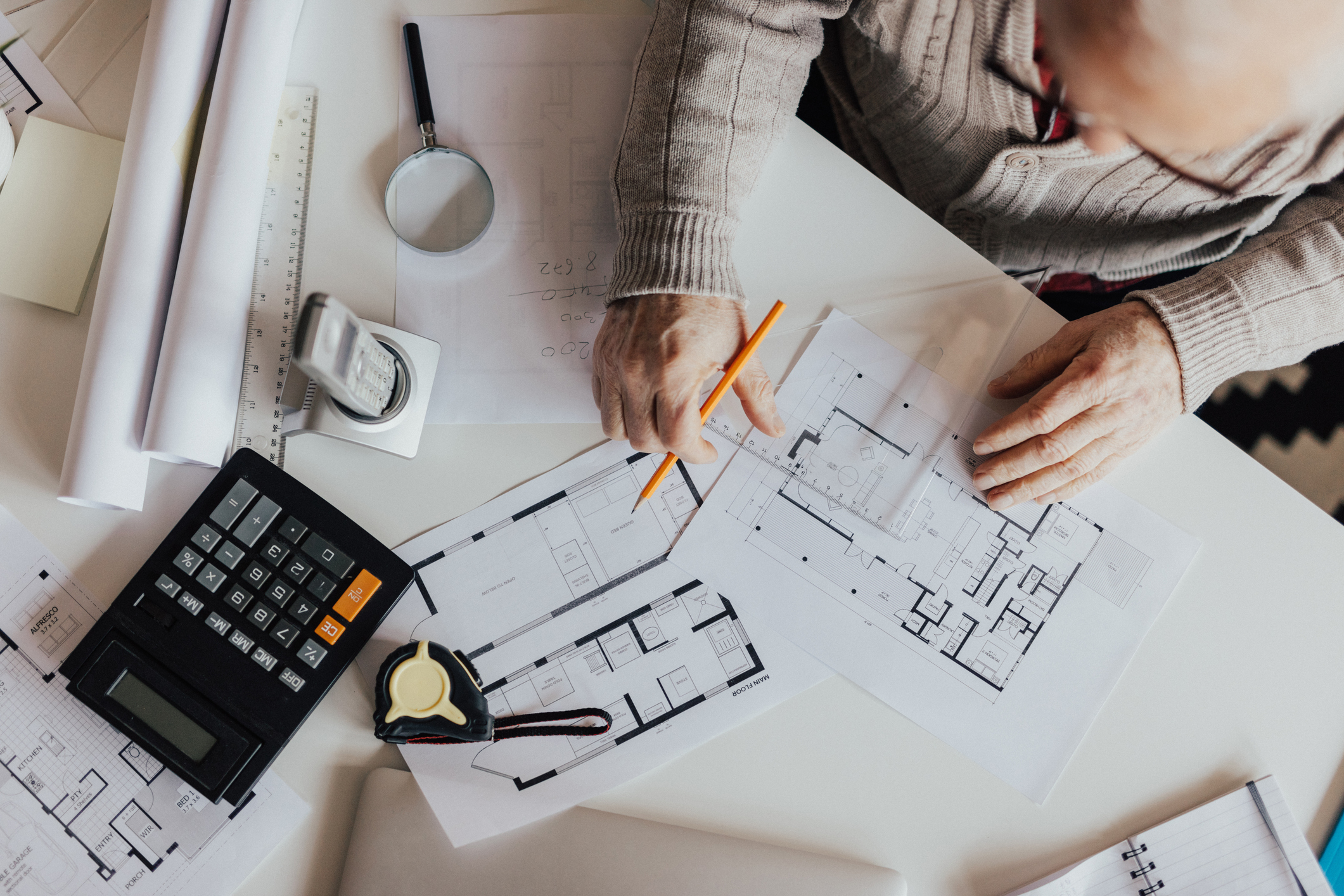 Top view of a person planning a home renovation.