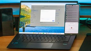 Using Nearby Share on phone next to the ASUS Chromebook CX9 for file transfer on a desk