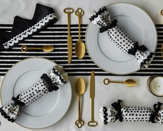 Overhead monochrome Christmas tablescape with reusable crackers