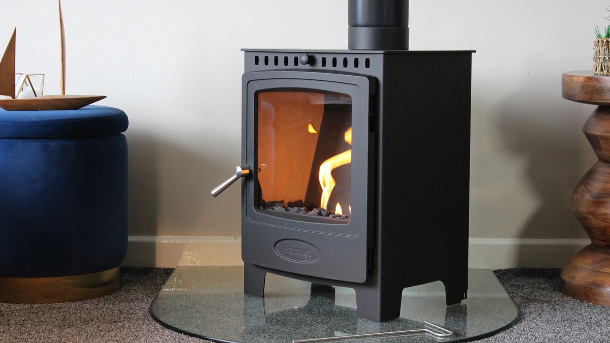 black bioethanol log stove style burner on glass hearth in living room