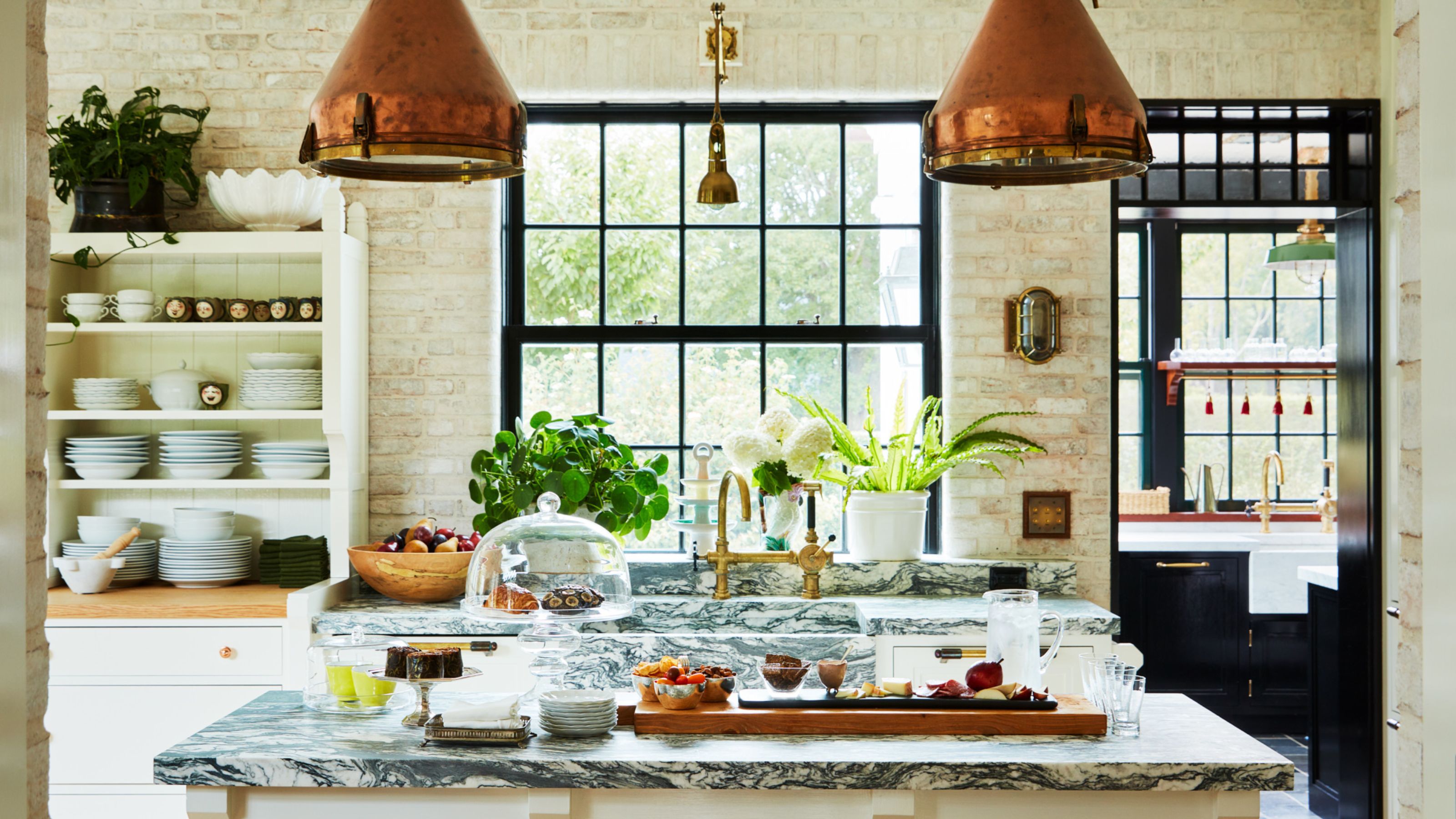 Bryan Graybill&#039;s kitchen with copper pendant lights and marble kitchen island