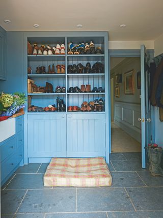 boot room with blue painted cabinets