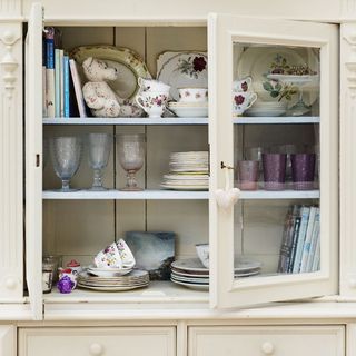 open crockery shelve with cup and saucer