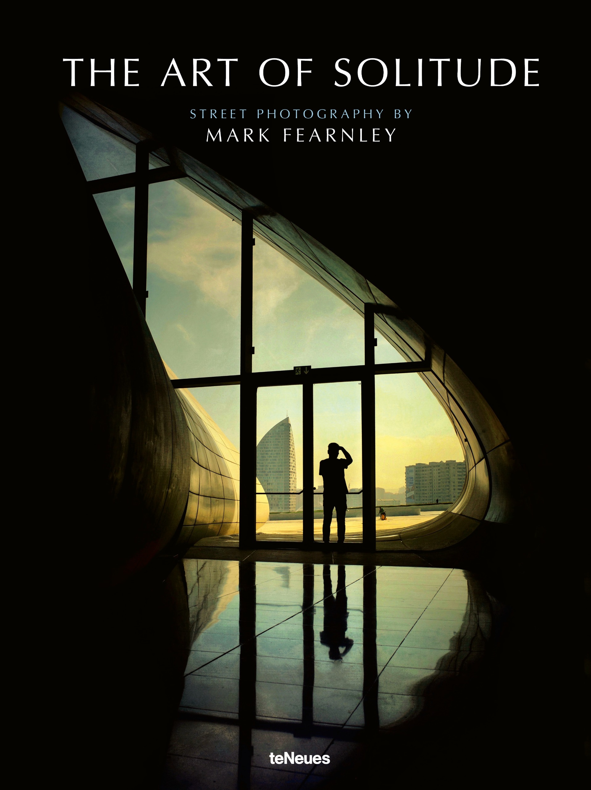 The silhouette of a man shading his eyes stands in a tall, teardrop-shaped window inside a curving modern building, looking out at a hazy city skyline, his reflection stretching across a floor.