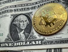 Novelty Bitcoin token is photographed on a US Dollar bank note