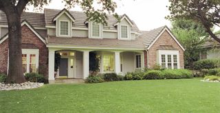 house exterior with a mowed lawn to show how to make your house look expensive from the outside with lawn maintenance