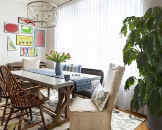 Traditional dining area with gallery wall using children's art and craft projects