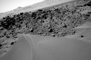 During ascent, Curiosity snapped this shot of the surrounding terrain, a view that demonstrates the upward slope of the dune.