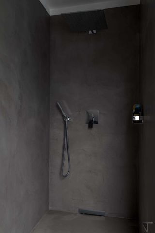 a dark grey microcement shower