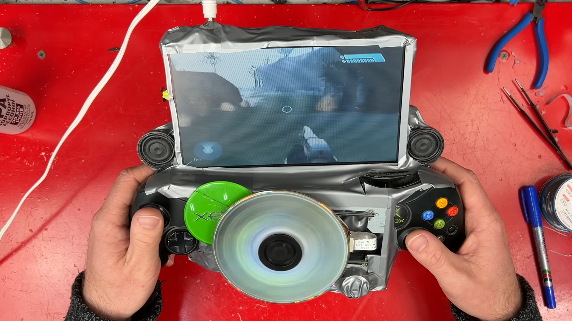 James in James Channel video using home made Xbox handheld to play Halo with disc spinning at the front.