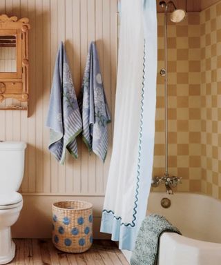 anthropologie curated cottage collection bathroom with yellow and cream checkerboard shower tiles