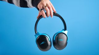 H2O RIPT Ultra headphones in black with blue accents photographed on a blue background