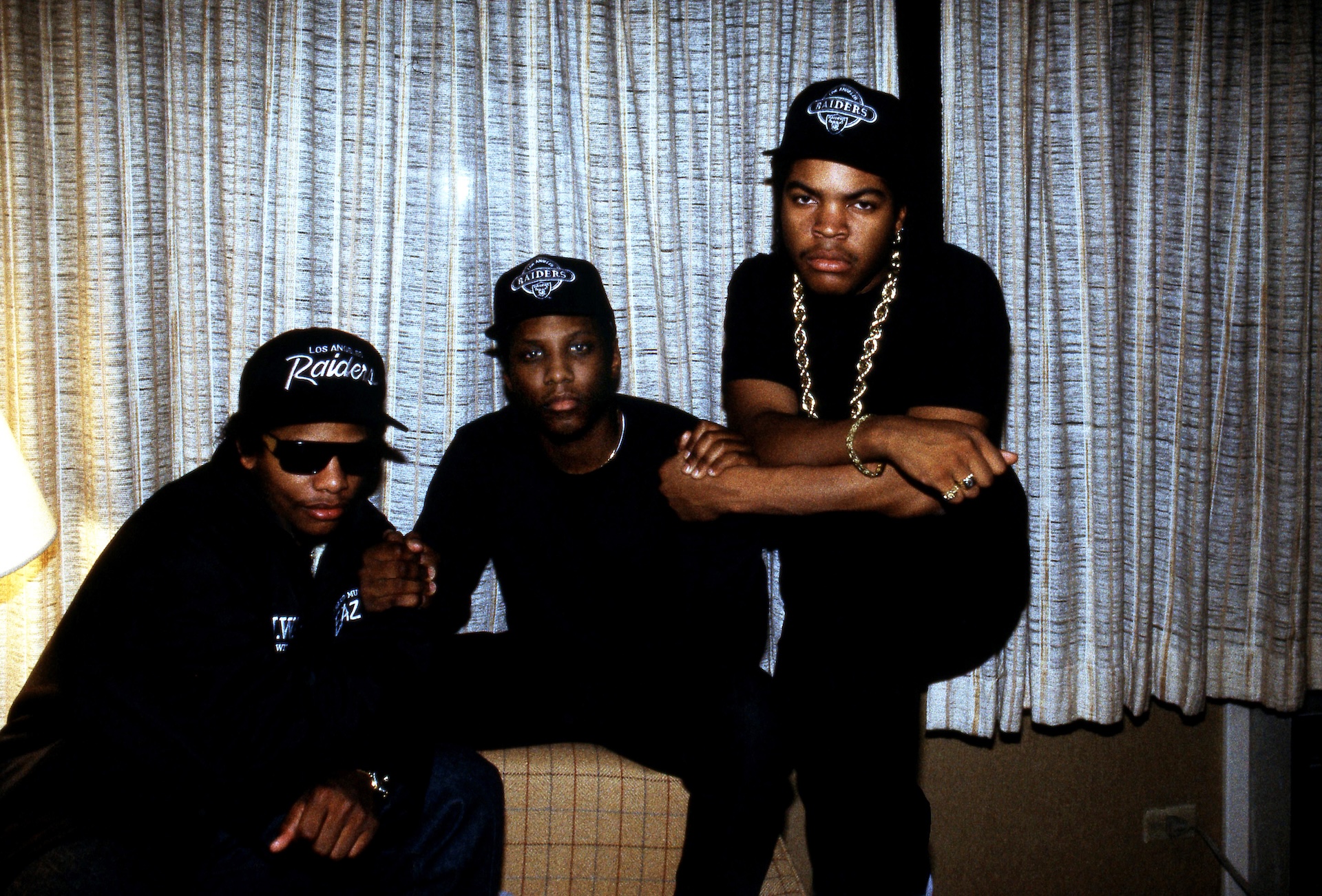 Rappers Eazy-E (Eric Lynn Wright), MC Ren (Lorenzo Jerald Patterson) and Ice Cube (O'Shea Jackson) of N.W.A. poses for photos after an interview at the Holiday Inn Lakeshore in Chicago, Illinois in February 1989