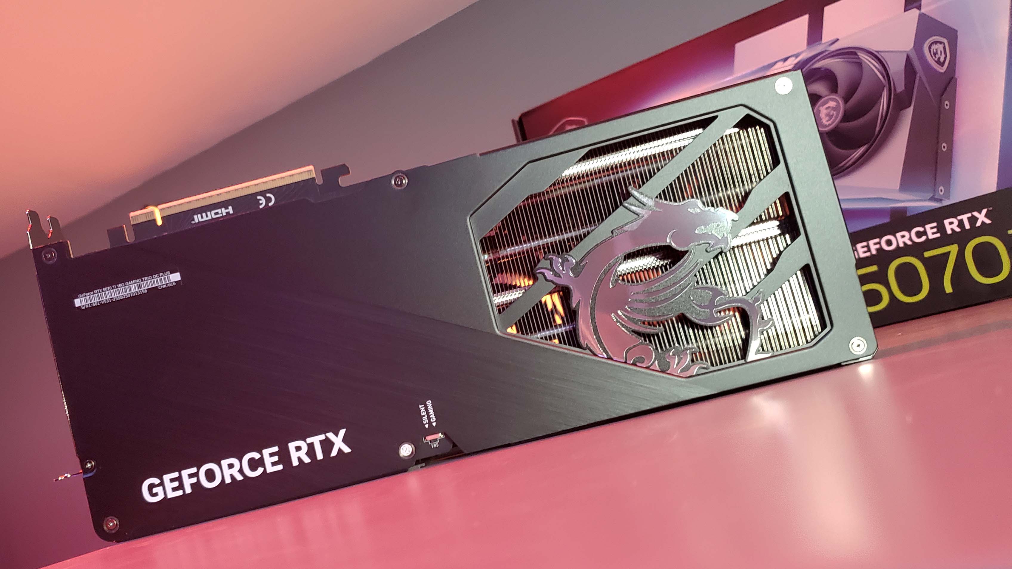 MSI RTX 5070 Ti Gaming Trio OC Plus graphics card under a red light