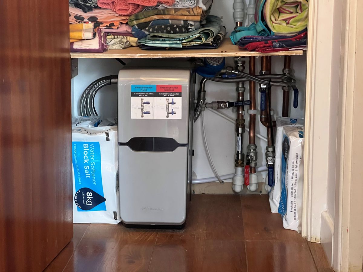 David Hilton&#039;s water softener inside a cupboard with salt stacked up beside it