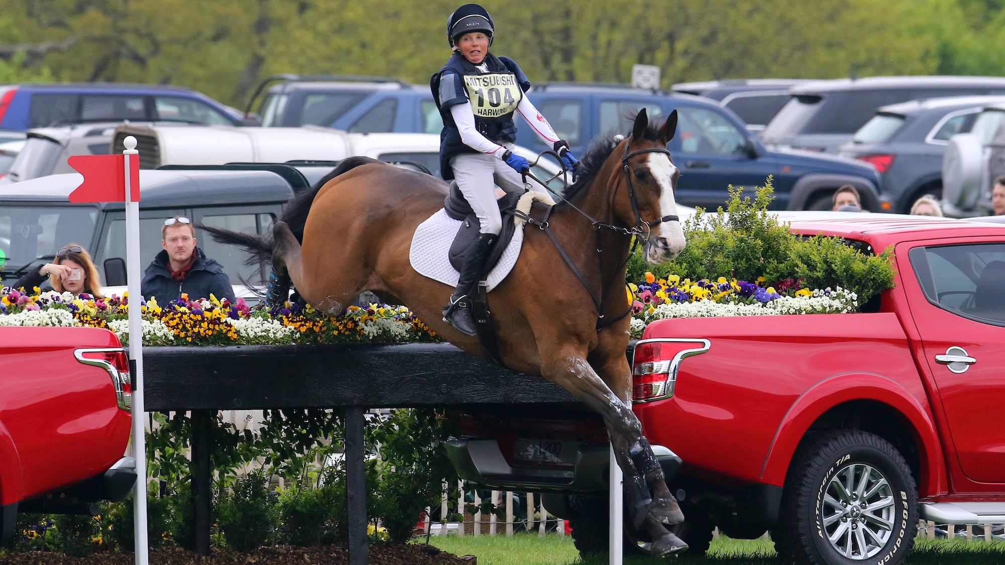 Louise jumps a cross-country fence on a bay horse
