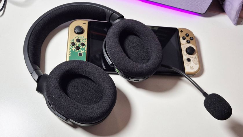 Image of the Razer Barracuda X Chroma gaming headset sitting on the Tears of the Kingdom Nintendo Switch OLED while on a white desk.