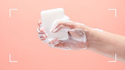 Woman holding a bar of foamy soap outstretched to illustrate how to clean a vibrator
