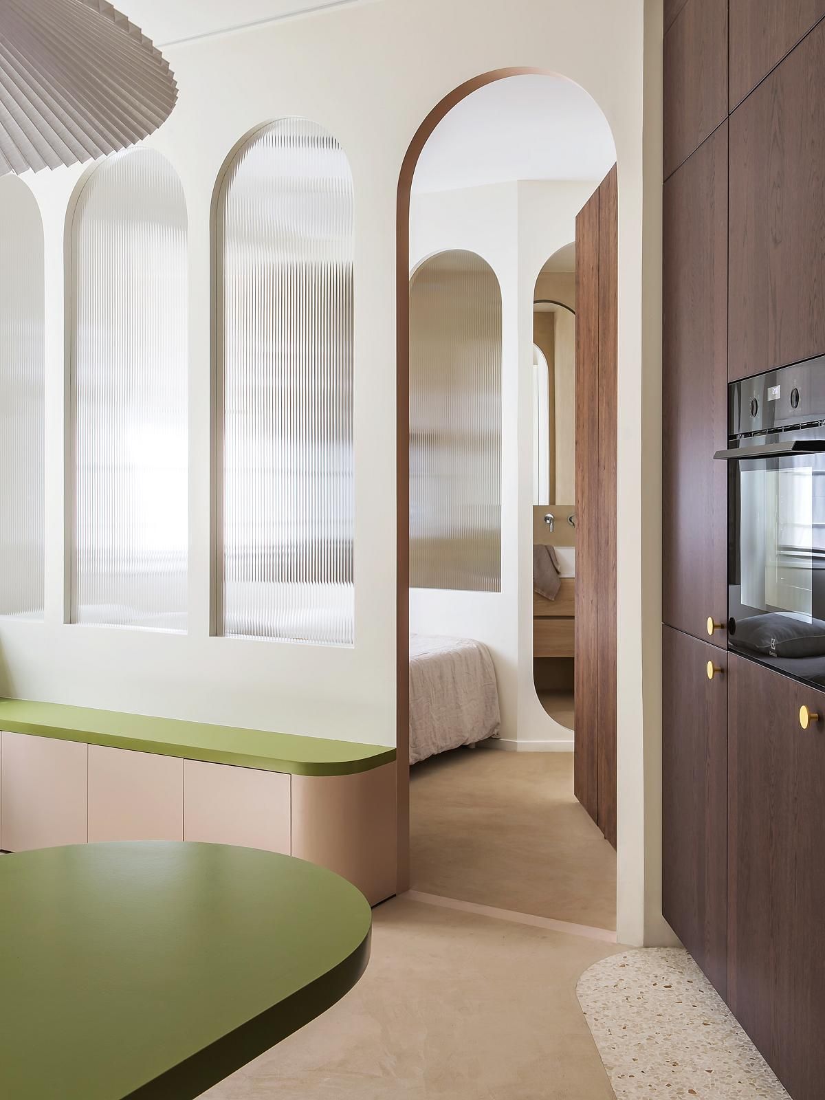 A living room, bedroom and kitchen adjoined in a small apartment