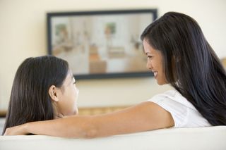 mother and daughter watching TV