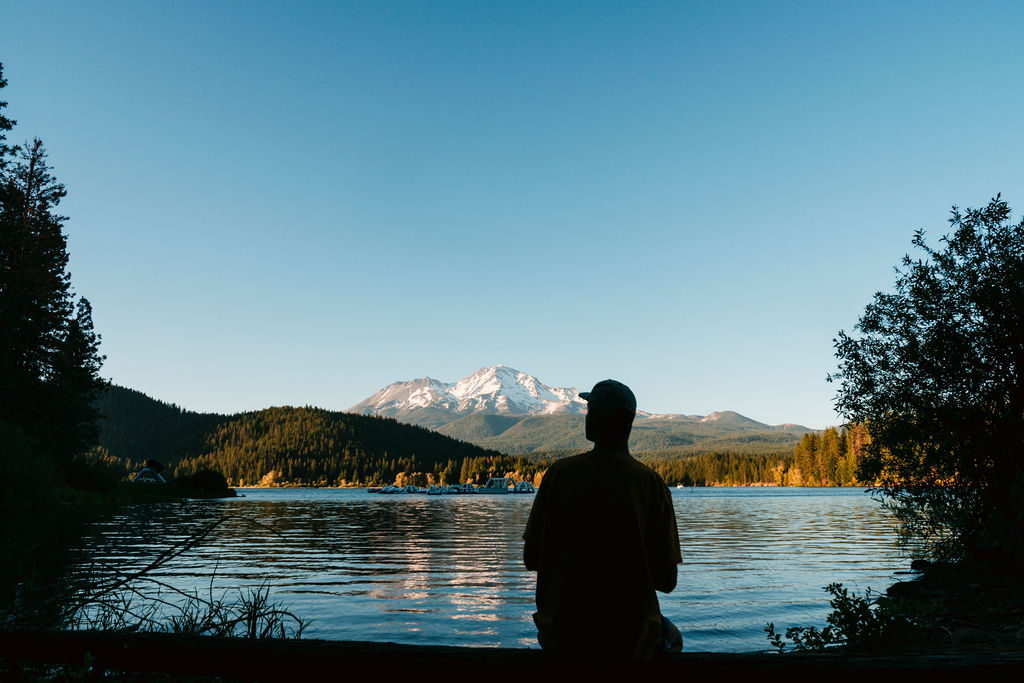 A man looks out at Lake Siskiyou on a clear day